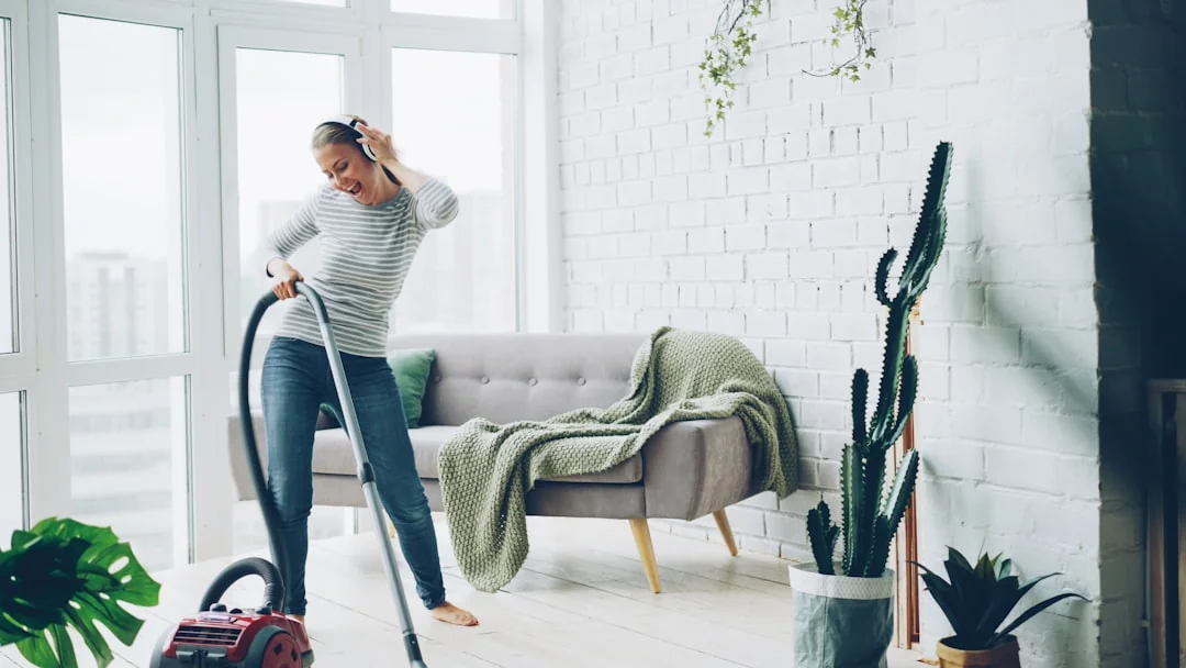 A couple collaboratively lifting a couch while moving into a new apartment.